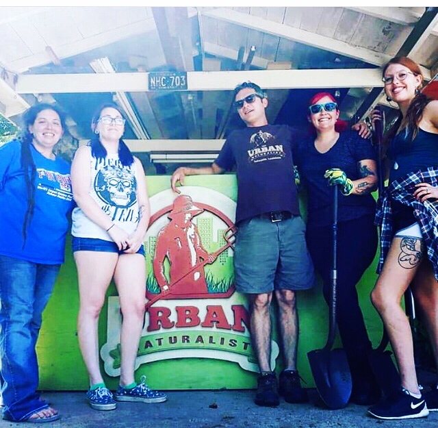 The Urban Naturalist crew in front of the sign